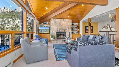 a living room with couches and a stone fireplace at Primavista Luxury Home at Windcliff condo in Estes Park