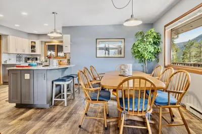a kitchen and dining room with a wooden table and chairs at Primavista Luxury Home at Windcliff condo in Estes Park