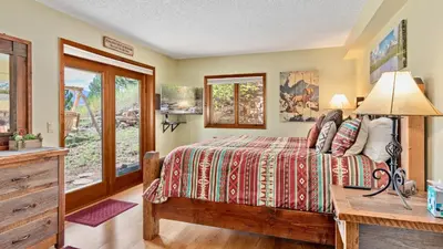 a bedroom with a bed and a desk with a lamp at Divine Destiny Luxury Home at Windcliff condo in Estes Park