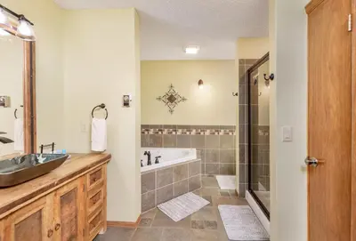 a bathroom with a tub and a sink at Divine Destiny Luxury Home at Windcliff condo in Estes Park