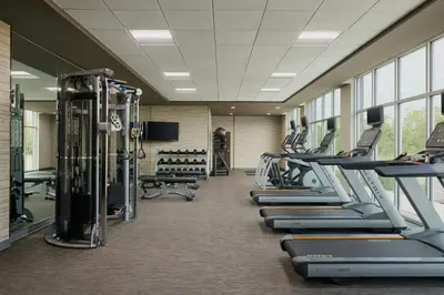 a gym with rows of treadmills and machines at Courtyard Denver Aurora in Aurora