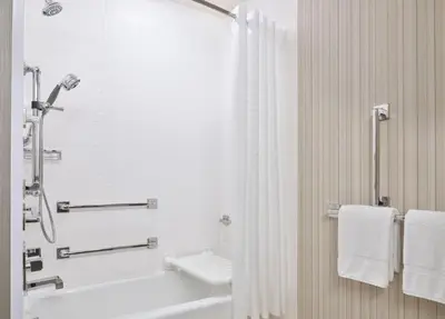 a bathroom with a shower and a sink and a tub at Courtyard Denver Aurora in Aurora