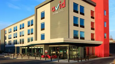 a building with an amazon office on the front at Avid Hotels - Denver Airport Area by IHG in Denver