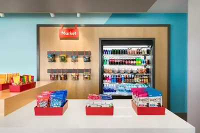a grocery store with a refrigerator with drinks at Avid Hotels - Denver Airport Area by IHG in Denver