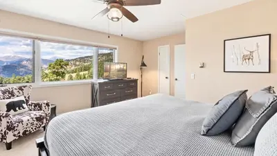 a bedroom with a bed and a window at Wanderlust Luxury Vacation Home at Windcliff condo in Estes Park
