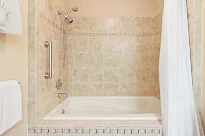a bathroom with a tub and a shower at Wanderlust Luxury Vacation Home at Windcliff condo in Estes Park