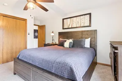 a bedroom with a bed and a ceiling fan at Wanderlust Luxury Vacation Home at Windcliff condo in Estes Park