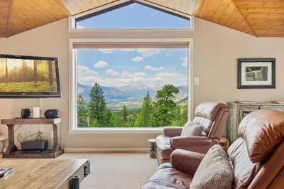 a living room with a large window at Wanderlust Luxury Vacation Home at Windcliff condo in Estes Park