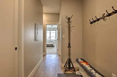 a hallway with a room with a weapon on the wall at Newly Built Ski Condo with Hot Tub and Shuttle Access! in Winter Park