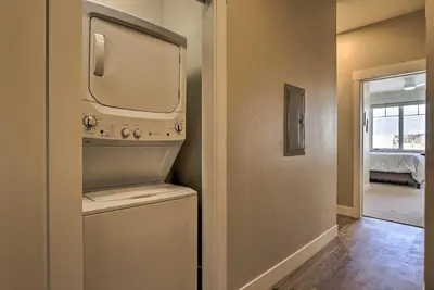 a small laundry room with a washer and dryer at Newly Built Ski Condo with Hot Tub and Shuttle Access! in Winter Park