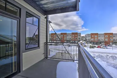 a balcony with a view of a building at Newly Built Ski Condo with Hot Tub and Shuttle Access! in Winter Park