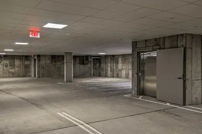 an empty parking lot with a door in a building at Newly Built Ski Condo with Hot Tub and Shuttle Access! in Winter Park