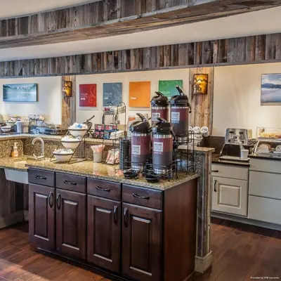 a large kitchen with a counter with at Quality Inn near Rocky Mountain National Park in Estes Park