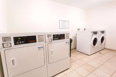 a laundry room with three washers and a dryer at Quality Inn near Rocky Mountain National Park in Estes Park