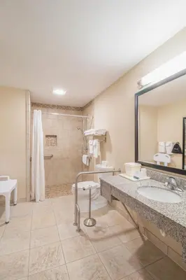 a bathroom with two sinks and a shower at Quality Inn near Rocky Mountain National Park in Estes Park