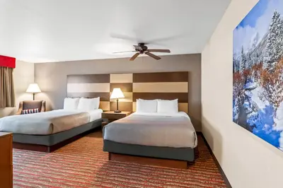 a hotel room with two beds and a ceiling fan at Quality Inn near Rocky Mountain National Park in Estes Park