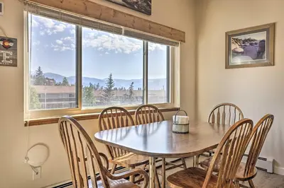 a dining room with a table and chairs and a window at Silverthorne Condo with Views about 11 Mi to Ski Slopes in Silverthorne