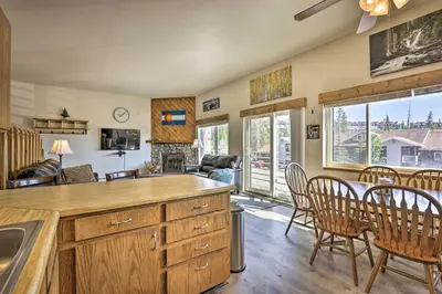 a kitchen and living room with a table and chairs at Silverthorne Condo with Views about 11 Mi to Ski Slopes in Silverthorne