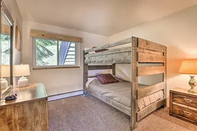 a bedroom with a bunk bed and a desk at Silverthorne Condo with Views about 11 Mi to Ski Slopes in Silverthorne