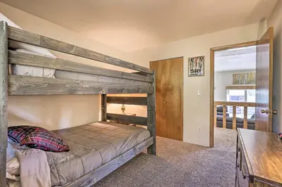 a bedroom with two bunk beds and a desk at Silverthorne Condo with Views about 11 Mi to Ski Slopes in Silverthorne