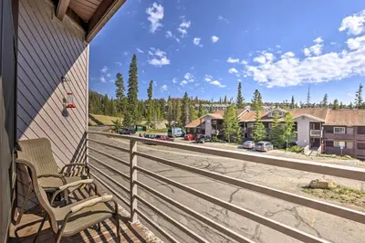 a balcony with a chair and a view of a street at Silverthorne Condo with Views about 11 Mi to Ski Slopes in Silverthorne