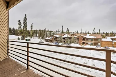 a view from the balcony of a resort in the snow at Silverthorne Condo with Views about 11 Mi to Ski Slopes in Silverthorne