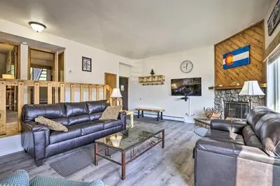 a living room with leather furniture and a fireplace at Silverthorne Condo with Views about 11 Mi to Ski Slopes in Silverthorne