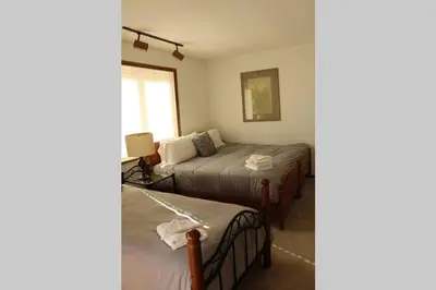 a bedroom with two twin beds and a window at Casa Colo in Fraser