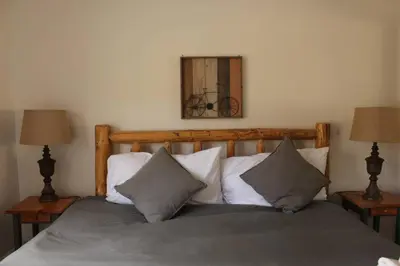 a bedroom with a bed with two lamps and a mirror at Casa Colo in Fraser