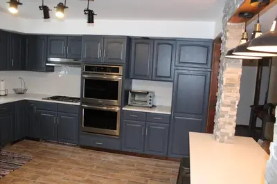 a kitchen with blue cabinets and a stove top oven at Casa Colo in Fraser