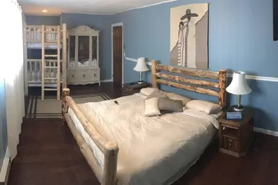 a bedroom with a large bed and a blue wall at Casa Vista in Fraser