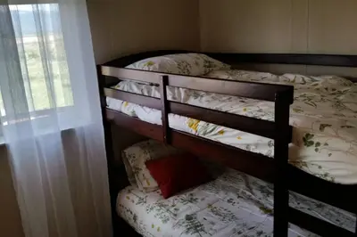 a four bunk bed in a room with a window at Casa Vista in Fraser
