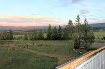 a view of a field with trees and a fence at Casa Vista in Fraser