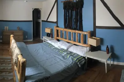 a bedroom with a bed with a blue wall at Casa Vista in Fraser