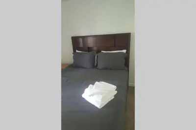 a bed with a pile of white towels on it at Casa Vista Granby in Granby