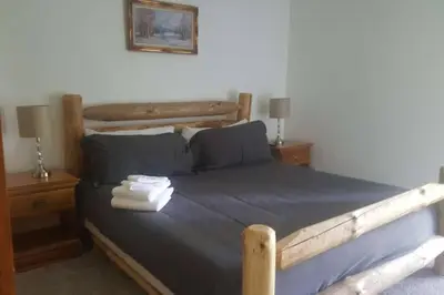 a bedroom with a bed with two towels on it at Casa Vista Granby in Granby