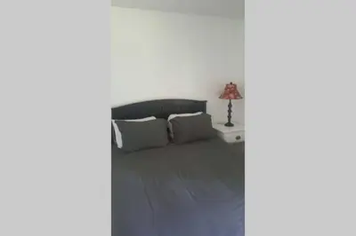 a bedroom with a bed and a lamp on a table at Casa Vista Granby in Granby