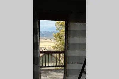 an open door to a balcony with a view at Casa Vista Granby in Granby