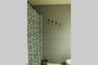 a bathroom with a toilet and a blue wall at Casa Vista Granby in Granby