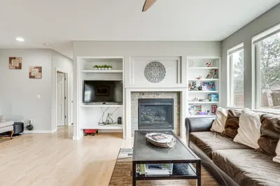 a living room with a couch and a fireplace at Fenced Yard and Trail Access Dog-Friendly Erie Home in Erie