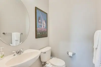 a bathroom with a sink and a toilet and a mirror at Fenced Yard and Trail Access Dog-Friendly Erie Home in Erie