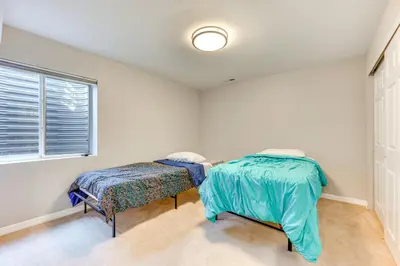 a bedroom with two beds and a window at Fenced Yard and Trail Access Dog-Friendly Erie Home in Erie