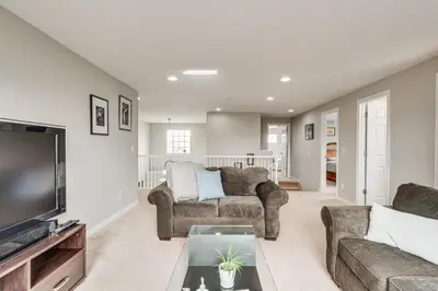 a living room with two couches and a tv at Fenced Yard and Trail Access Dog-Friendly Erie Home in Erie