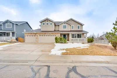 a house with a driveway in front of it at Fenced Yard and Trail Access Dog-Friendly Erie Home in Erie