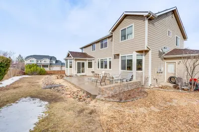 a house with a patio and a yard at Fenced Yard and Trail Access Dog-Friendly Erie Home in Erie