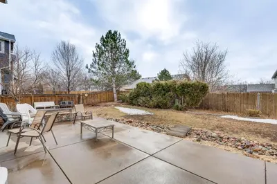 a patio with chairs and a table and a fence at Fenced Yard and Trail Access Dog-Friendly Erie Home in Erie