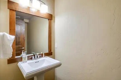 a bathroom with a white sink and a mirror at Frisco Condo with Rooftop Deck Walk to Main St! in Frisco