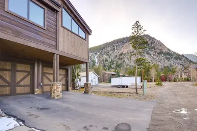 a house with a barn with a mountain in the background at Frisco Condo with Rooftop Deck Walk to Main St! in Frisco
