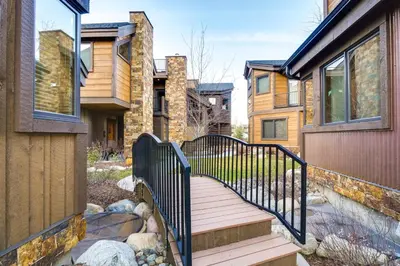 a wooden walkway leading to a house at Frisco Condo with Rooftop Deck Walk to Main St! in Frisco