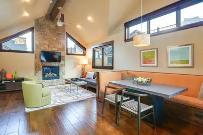 a living room with a couch and a table at Frisco Condo with Rooftop Deck Walk to Main St! in Frisco